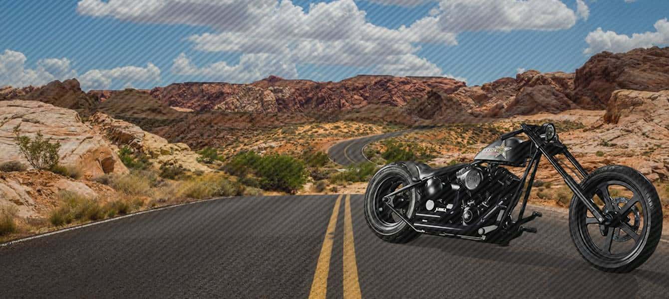 Custom V-twin running Lazer Star billet lights on a desert highway